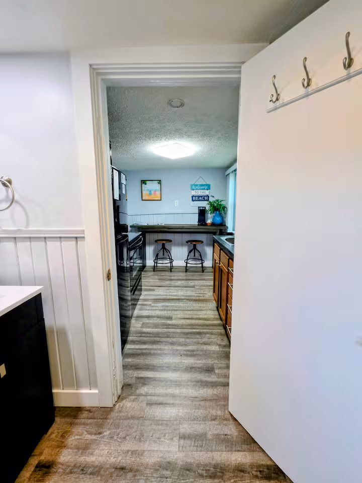 cottage dining area, kitchen, from bathroom